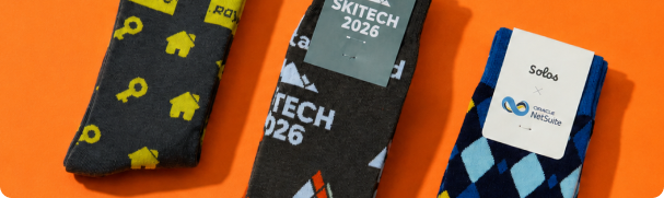 Three pairs of custom Solos socks on an orange background