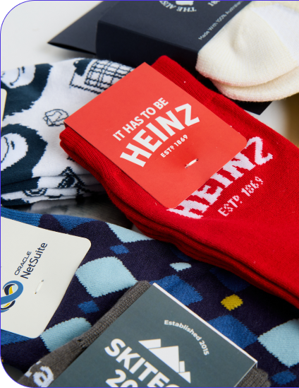 Custom Solos socks including Heinz, Skitech and NetSuite branded pairs